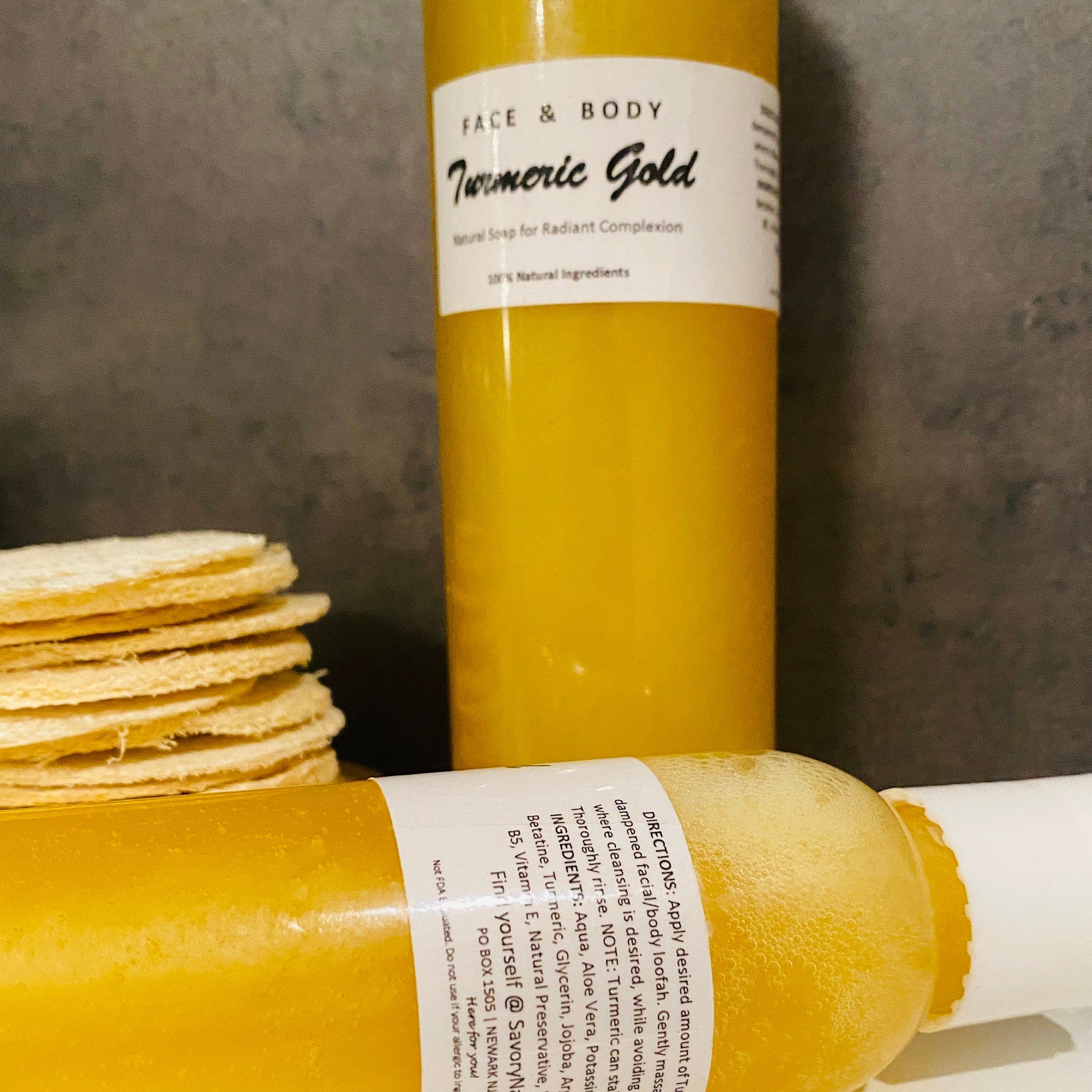 Golden turmeric liquid soap lathering on skin with natural loofah, showcasing creamy foam texture