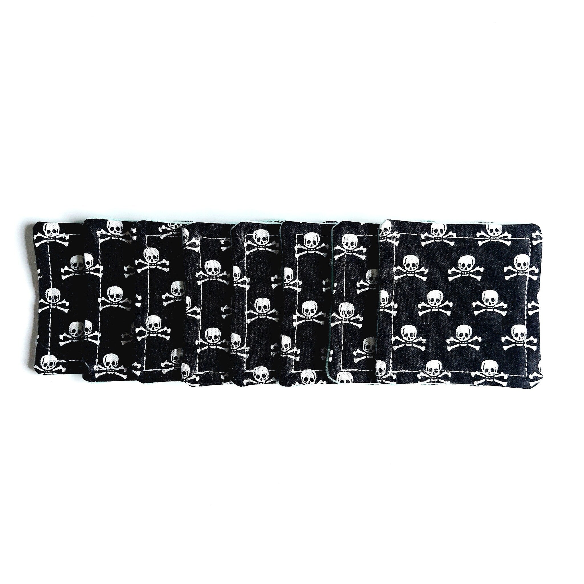 Coasters black fabric with white skull pattern, stacked together