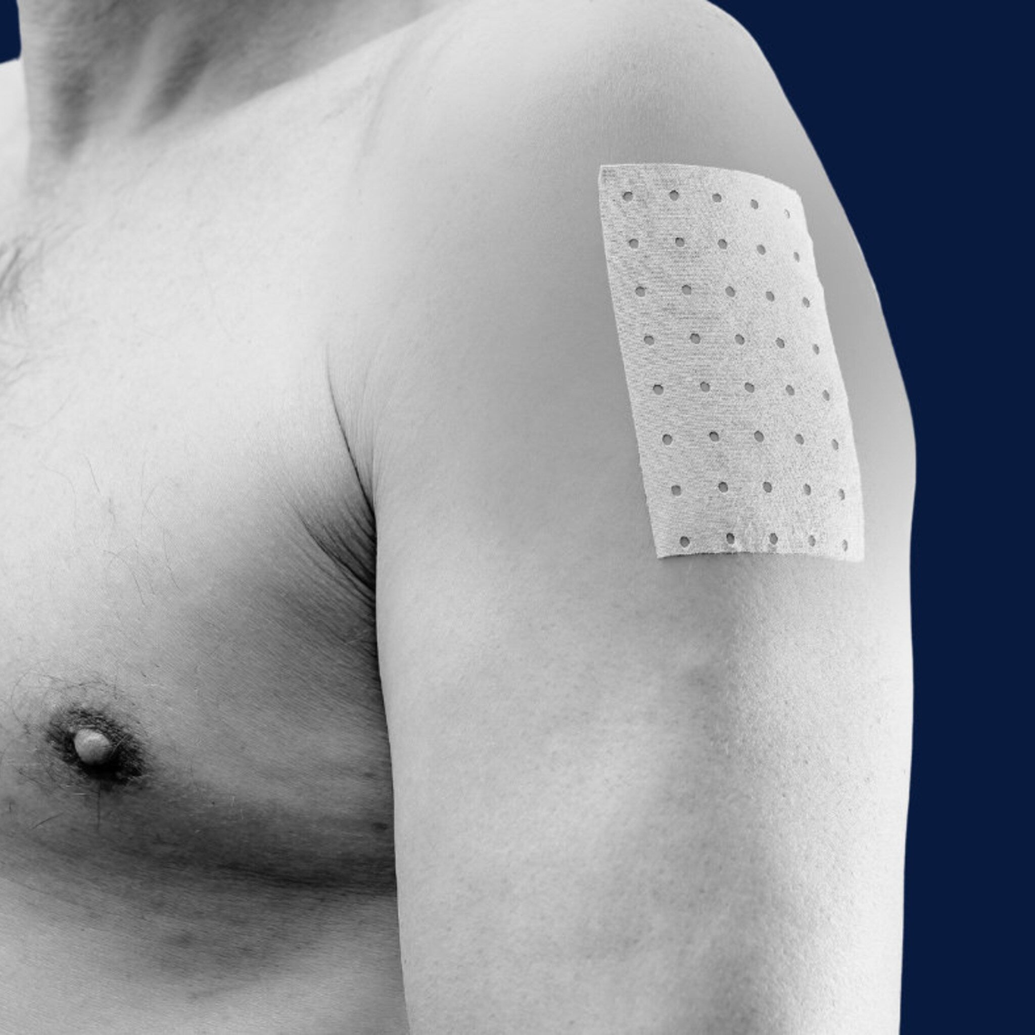 Adhesive bandage with white fabric and perforated pattern applied to human skin