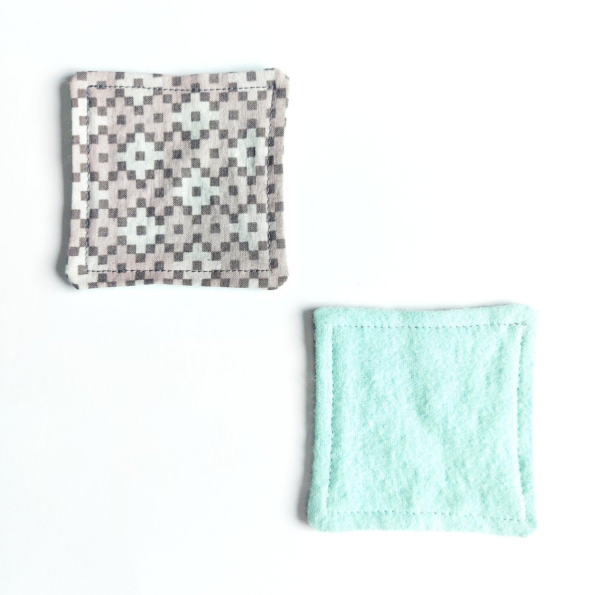 Reusable face pads with patterned and solid colors, stitched edges, and square shape