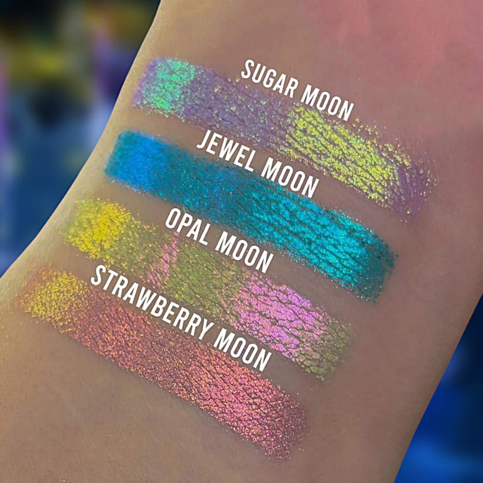 Open compact showing chrome shifting strawberry moon eyeshadow with reflective pink and gold tones