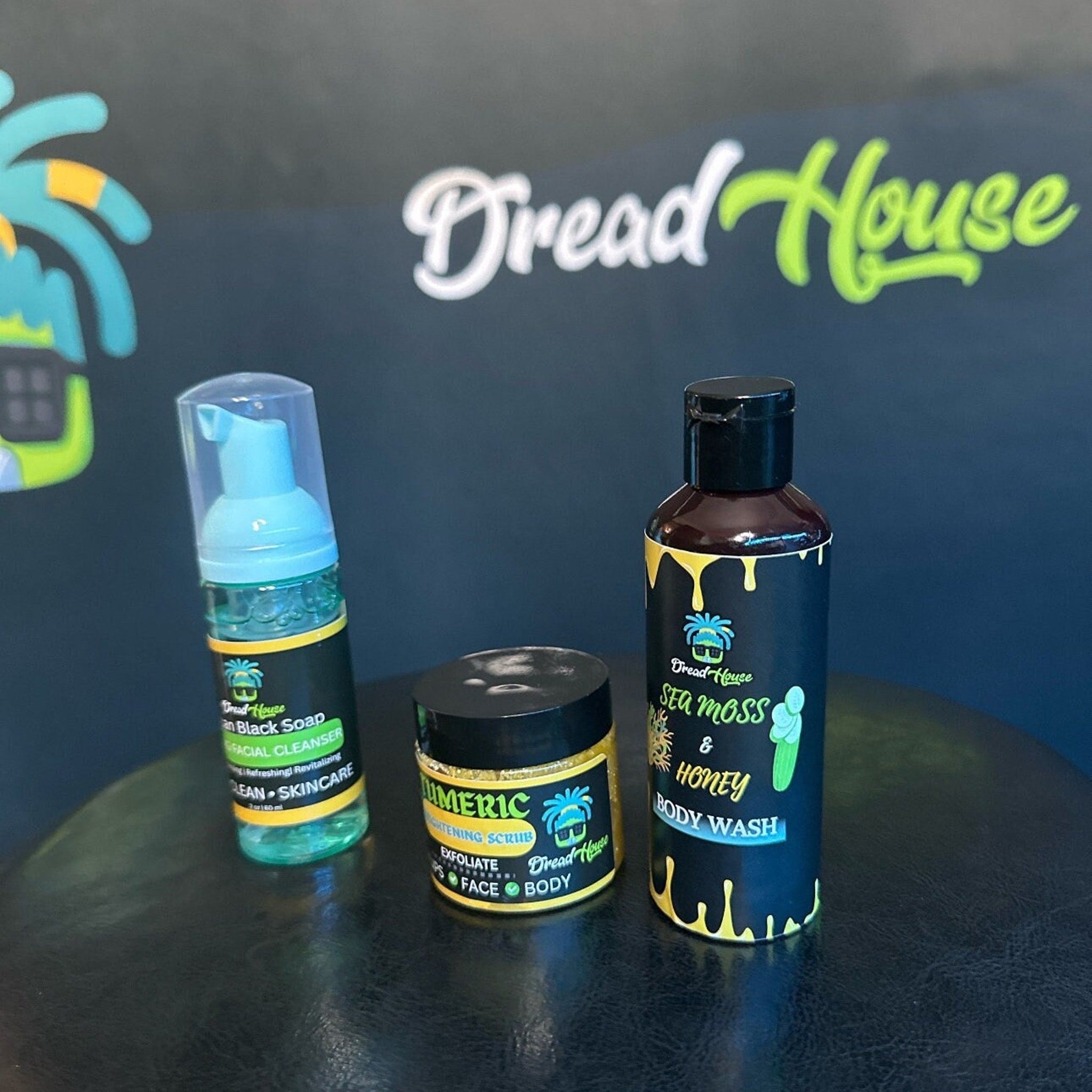 Facial cleanser bottles with blue, black, and yellow labels, Dread House branding visible
