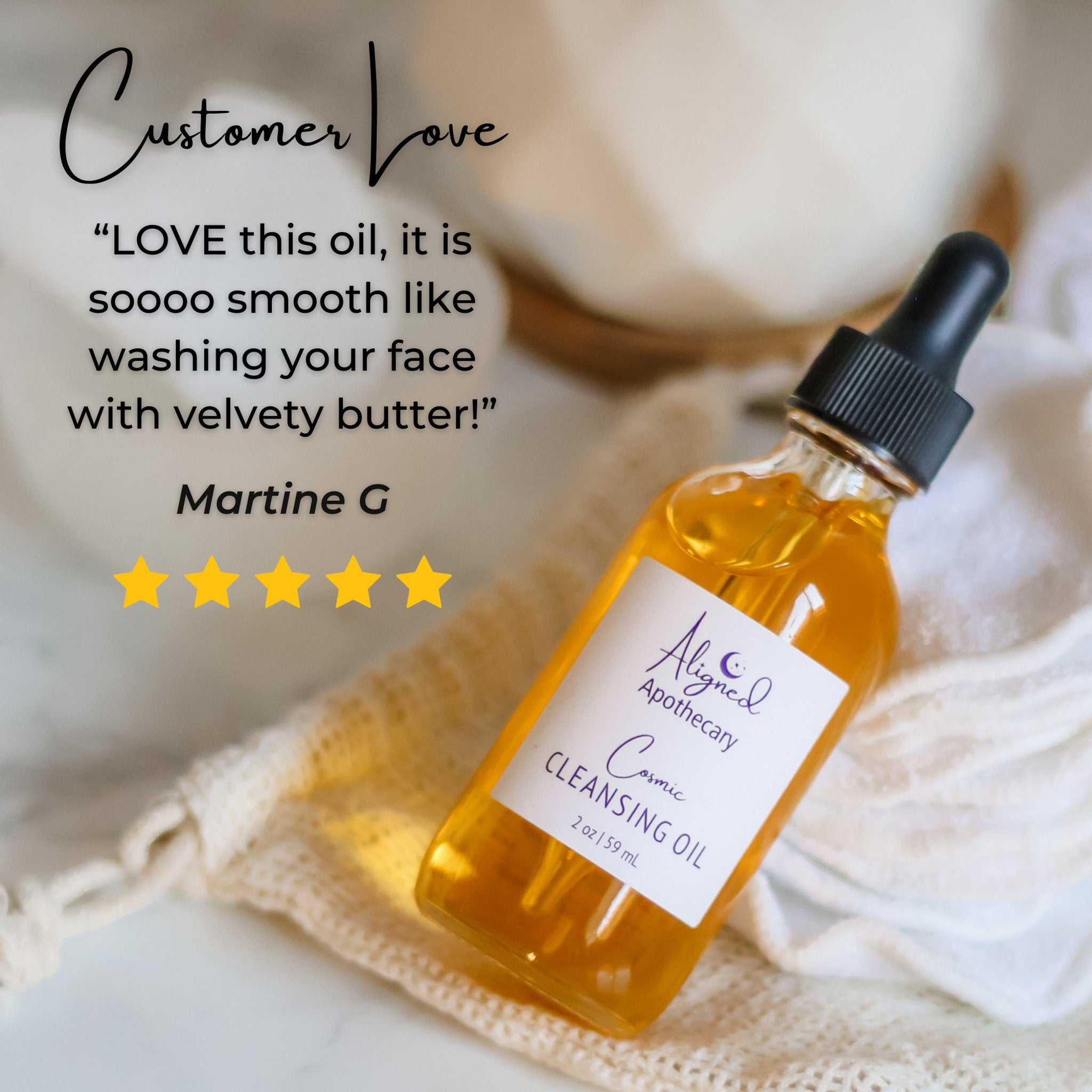 Cleansing oil bottle with amber liquid, black dropper, and white label, on a cream fabric