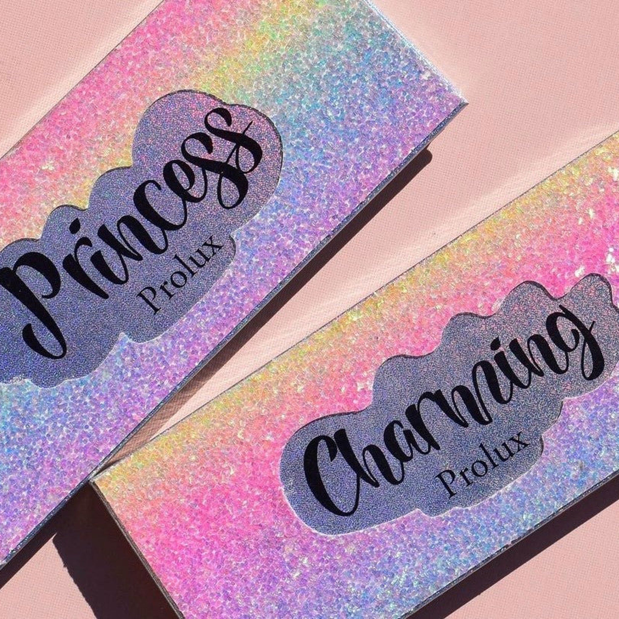 Glittery cosmetic packaging with "Princess" and "Charming" text, Prolux brand, pink and purple hues
