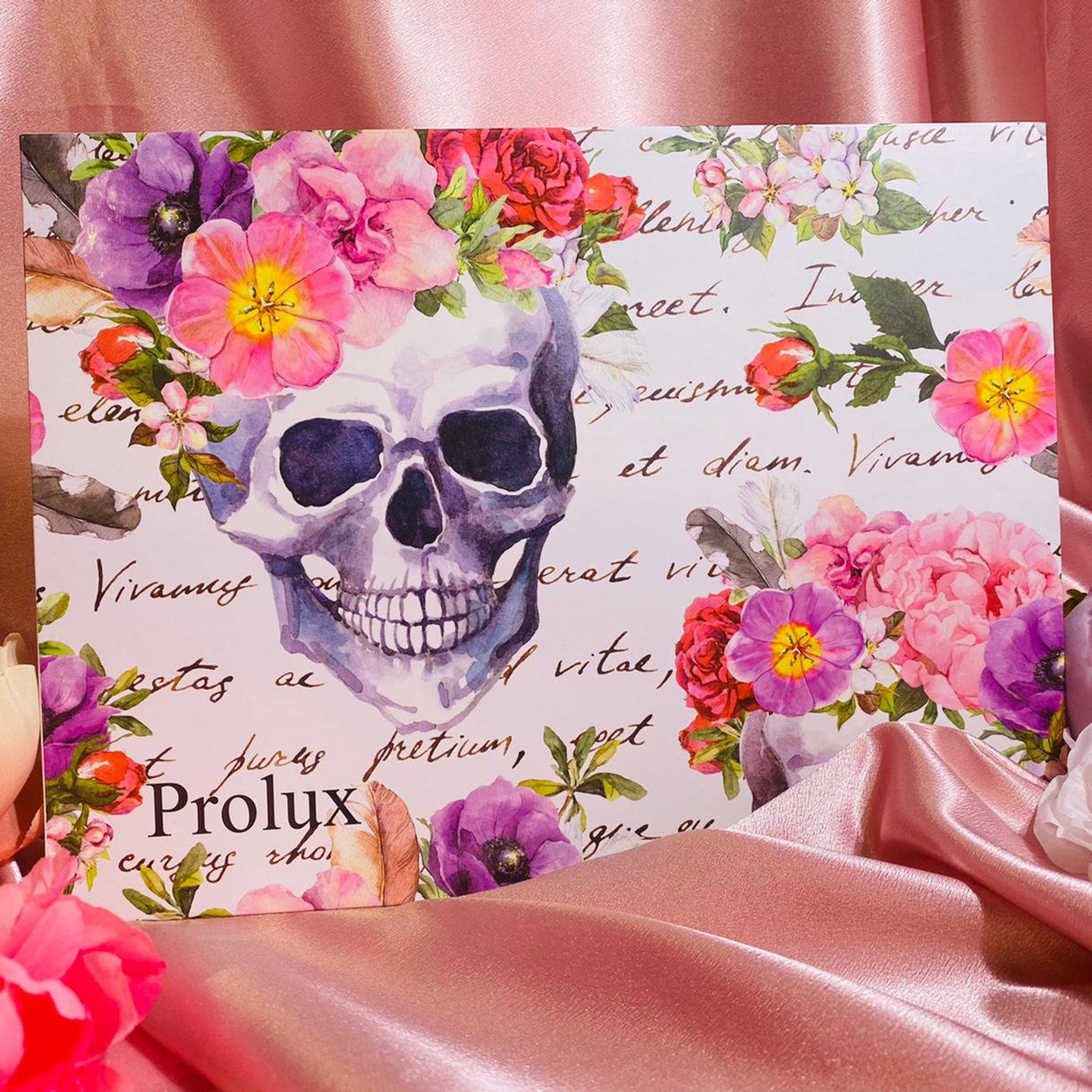 Close-up of vintage eyeshadow palette showing shimmering bronze and plum shades with embossed floral design