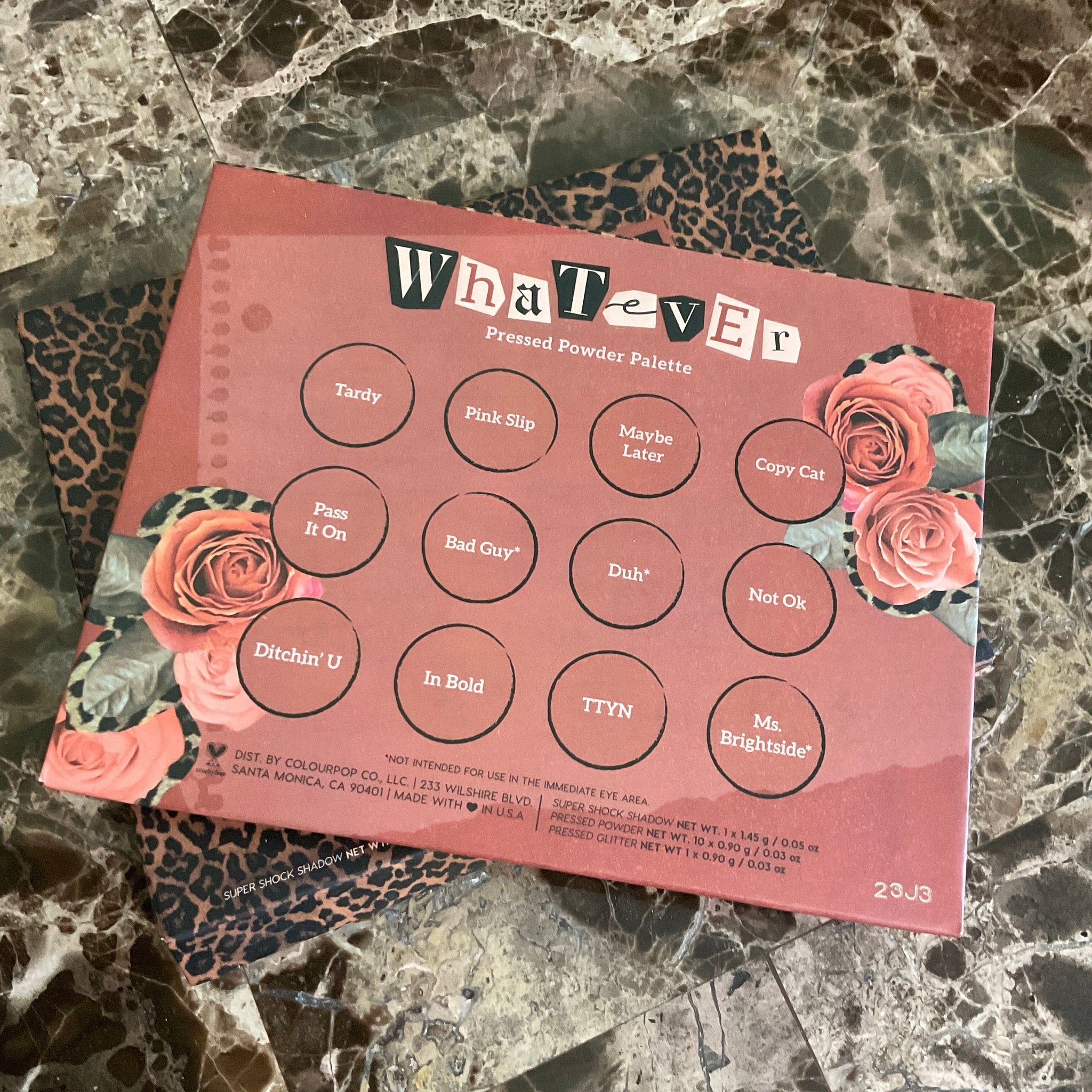 Close-up of Colourpop Whatever Palette showing six matte and shimmer eyeshadows in warm brown and pink tones with embossed logo