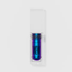 Close-up of shimmering liquid eye shadow in emerald green with metallic finish and doe-foot applicator