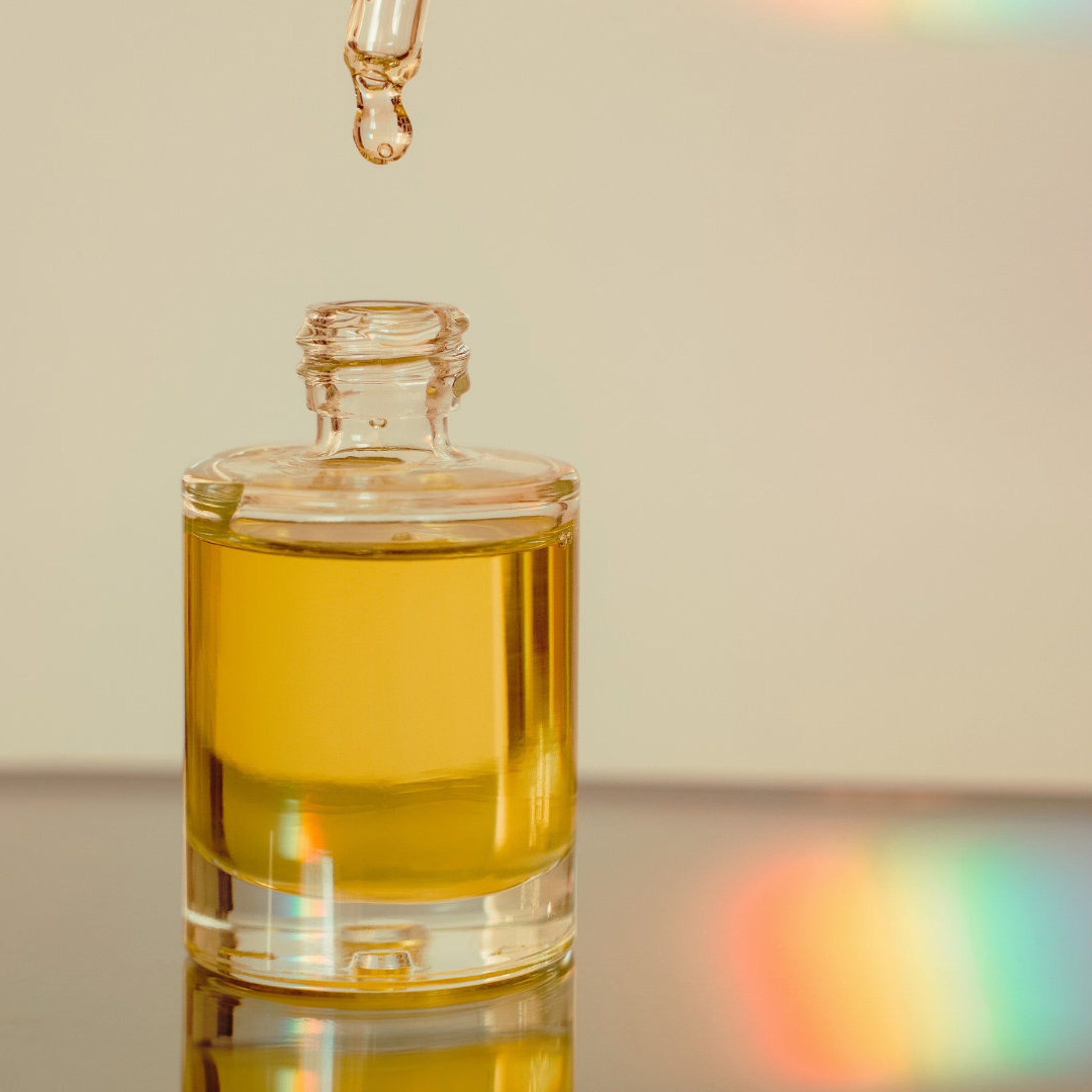 Dropper bottle with yellow liquid, glass material, clear bottle with dropper dispensing oil