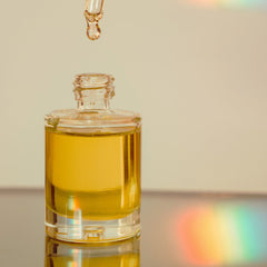Dropper bottle with yellow liquid, glass material, clear bottle with dropper dispensing oil