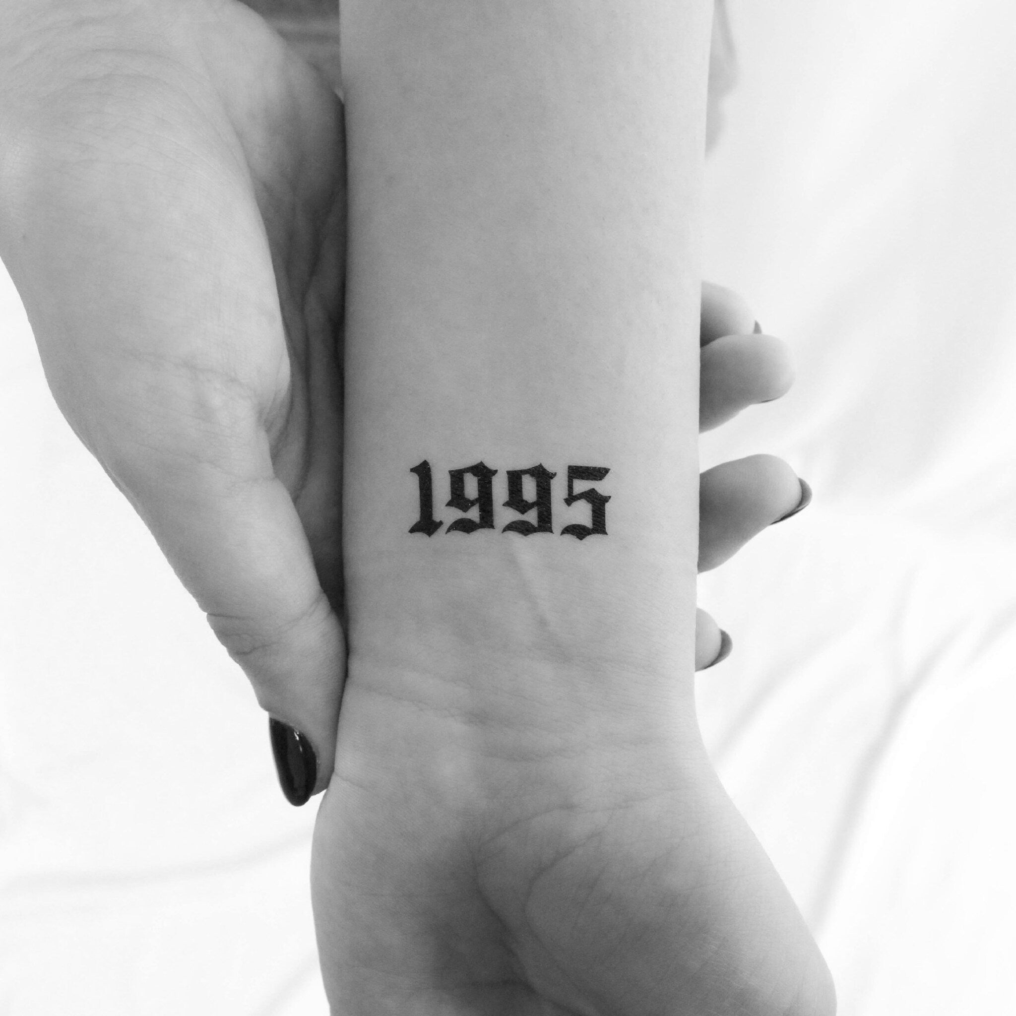 Set of gothic-style temporary tattoos in black ink designs on skin-friendly sheets