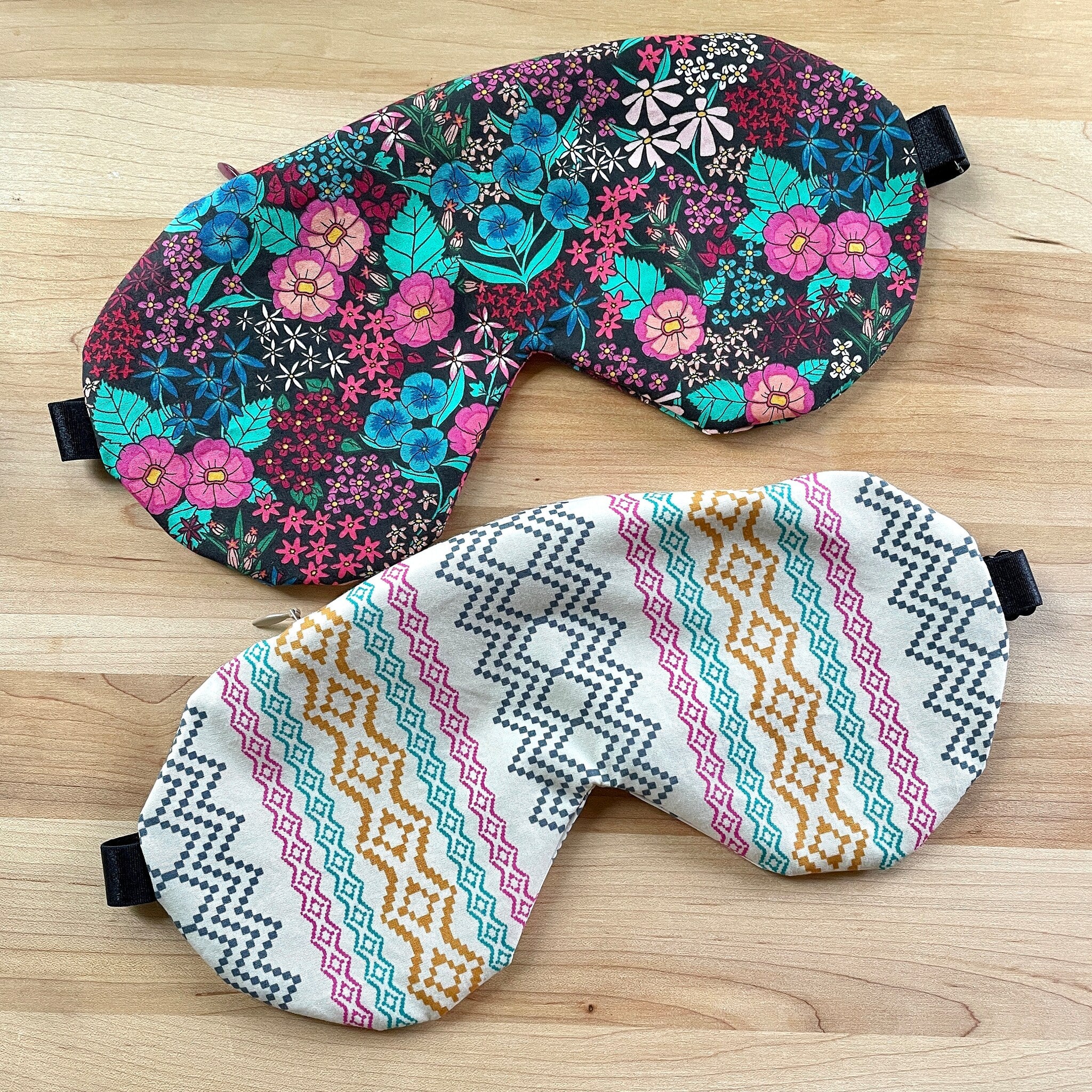 Sleep masks with floral and geometric patterns in various colors, with black elastic bands