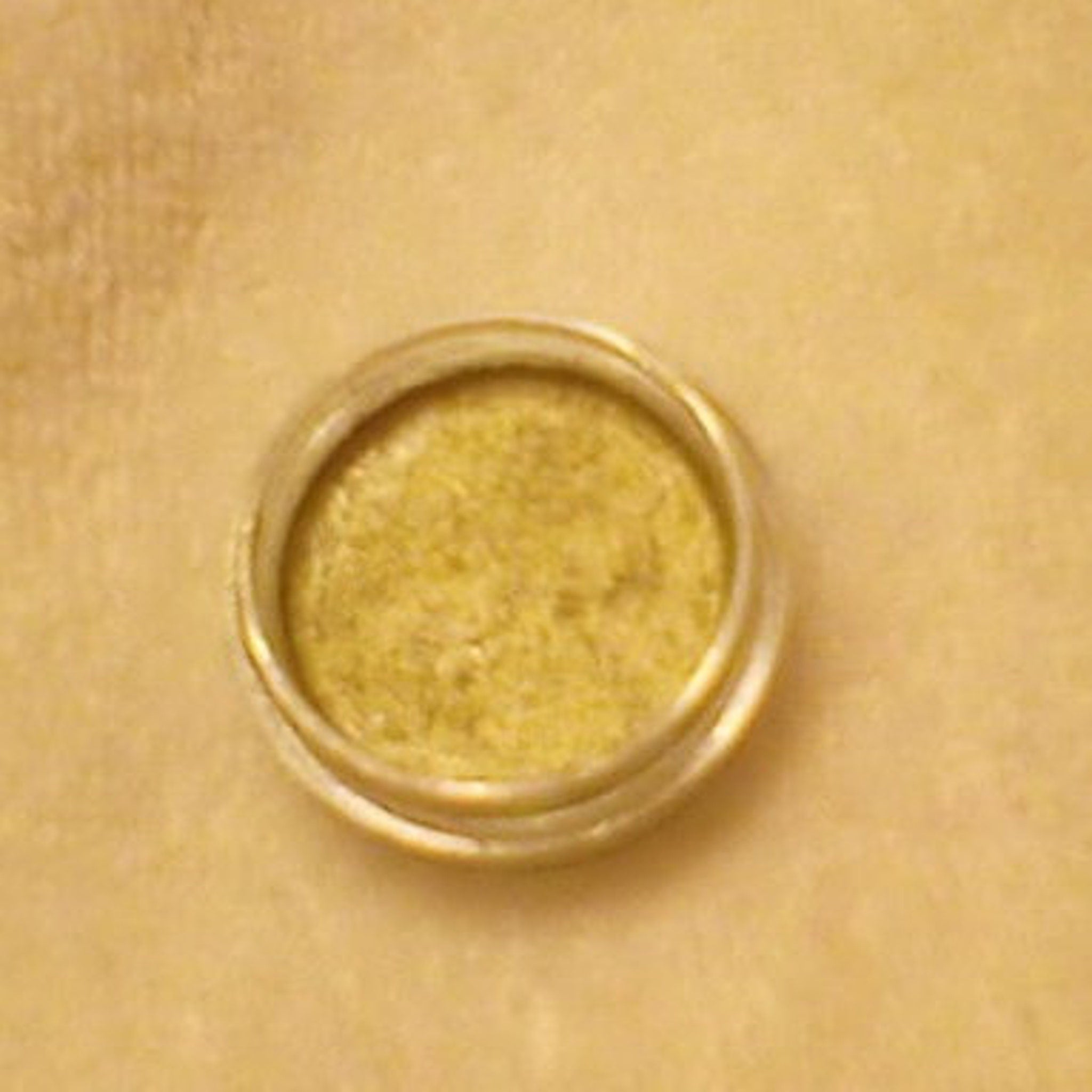 Side view of pressed powder eye shadow compact showing smooth matte finish and square edges