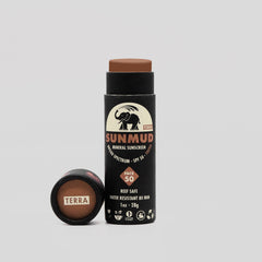 Sunscreen stick with brown tinted color, black packaging, and TERRA branding
