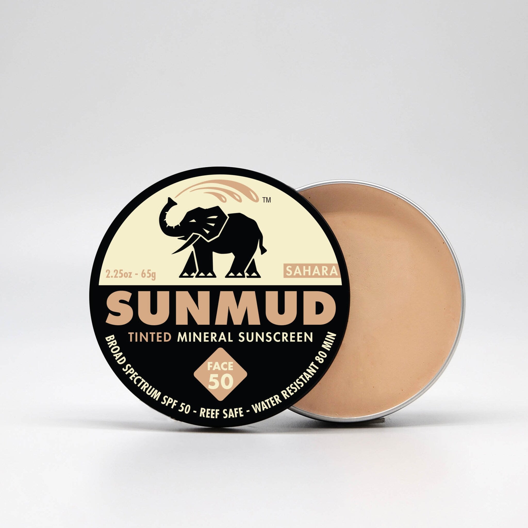 Tinted mineral sunscreen with black and tan label, beige cream, and SUNMUD brand name visible