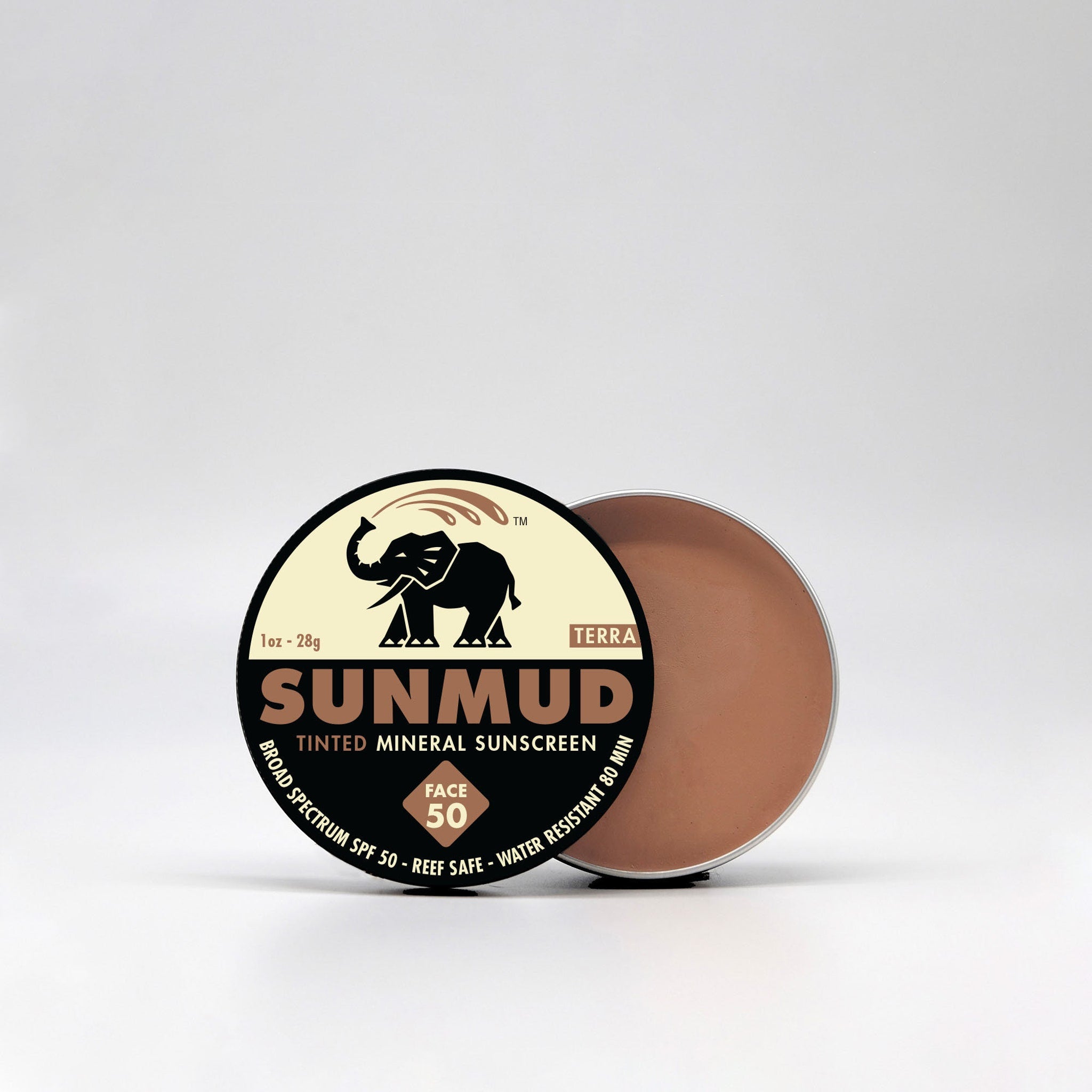 Sunscreen jar with brown cream, black and tan label, and silver rim SUNMUD brand visible
