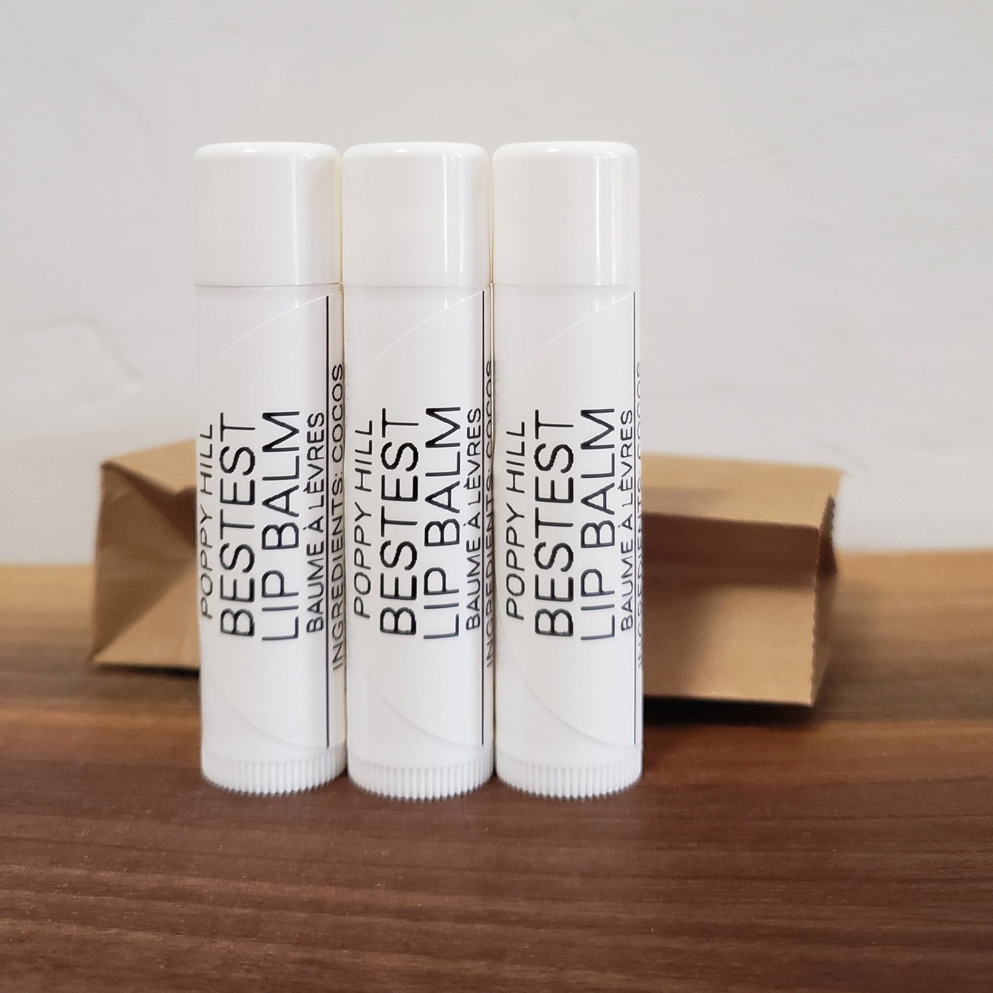 Lip balm tubes, white with black text, Bestest brand, three in a row