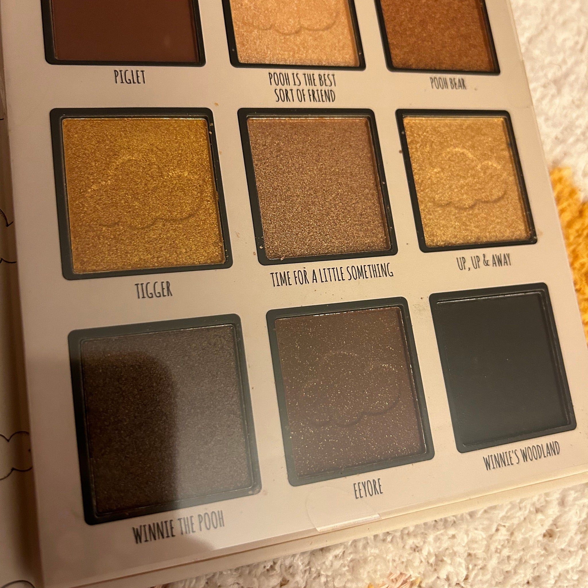Open Winnie the Pooh eyeshadow palette showing honeycomb design with warm brown and gold shades
