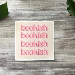 Close-up of matte book-themed vinyl sticker with intricate typography and vintage design details