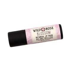 Lip balm tube with black cap, pink floral pattern, and Wild Rose Blossom label