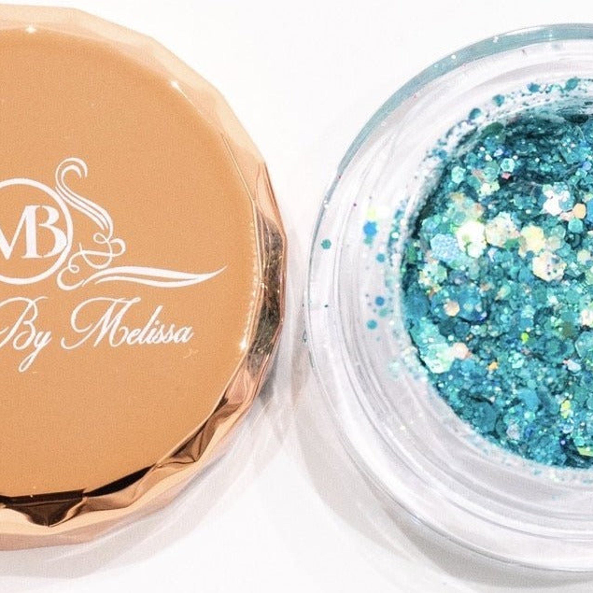 Side angle view of turquoise glitter eyeshadow pot showing shimmer particles catching light