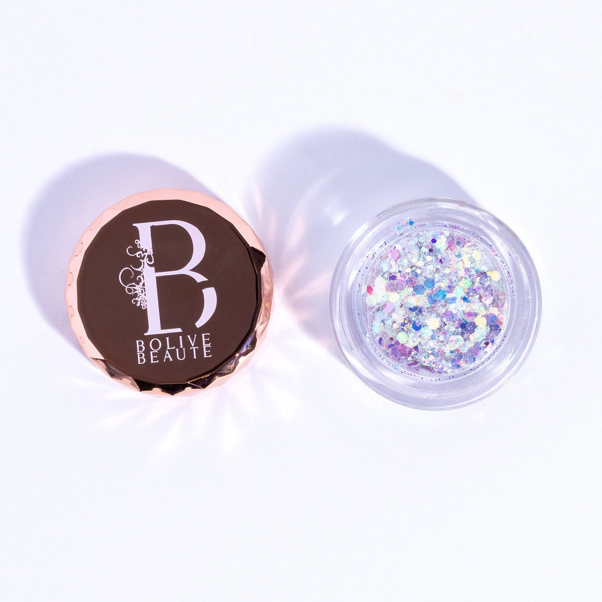 Close-up of iridescent white glitter eyeshadow palette with shimmering blue and pink hues in compact case