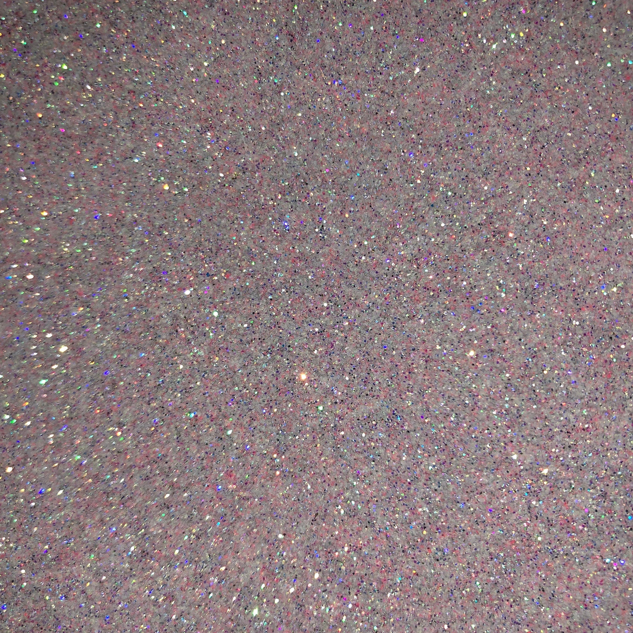 Close-up of iridescent pink fairy dust glitter eyeshadow with sparkling shimmer particles catching the light