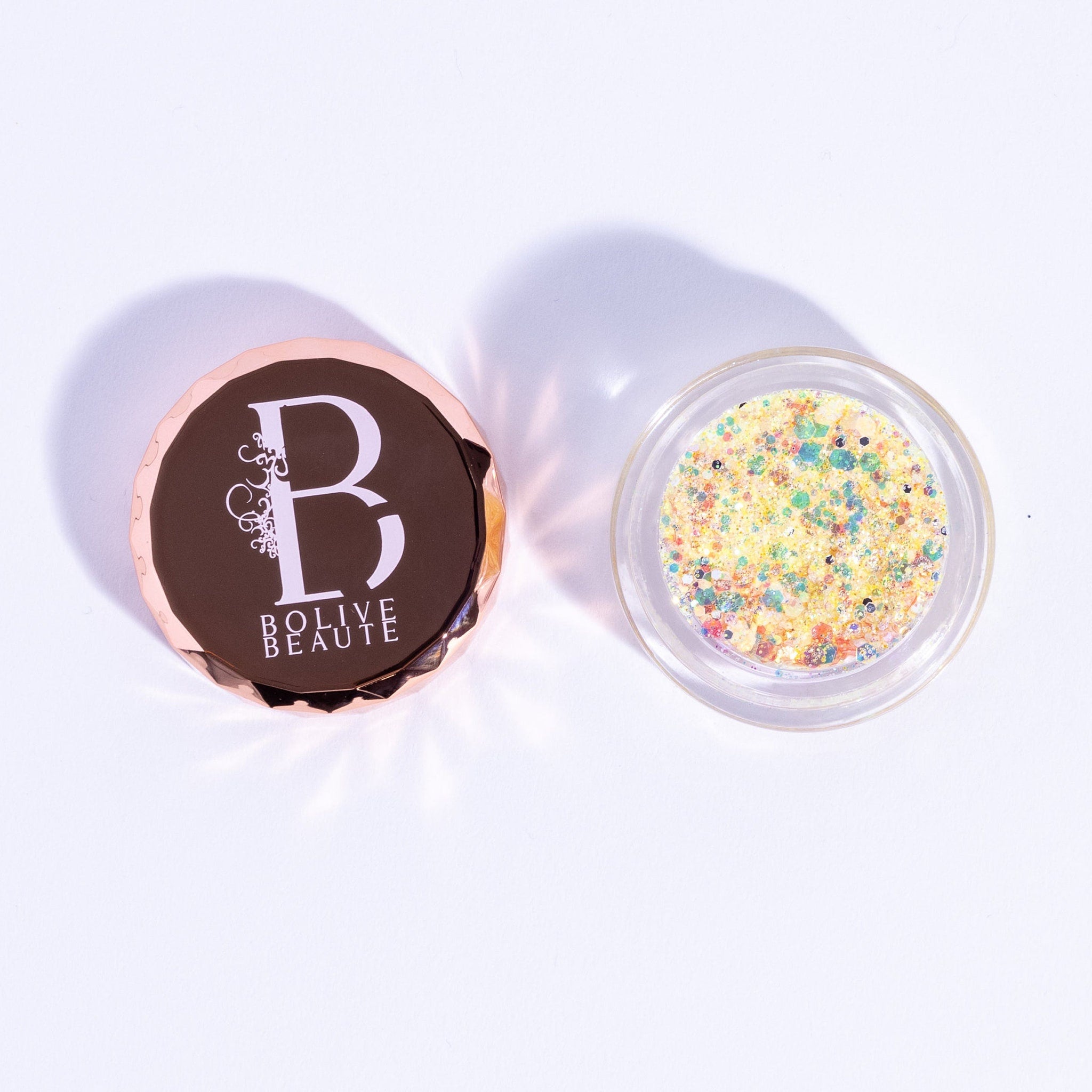Canary shade iridescent eyeshadow with vibrant yellow and pink glitter particles in compact case