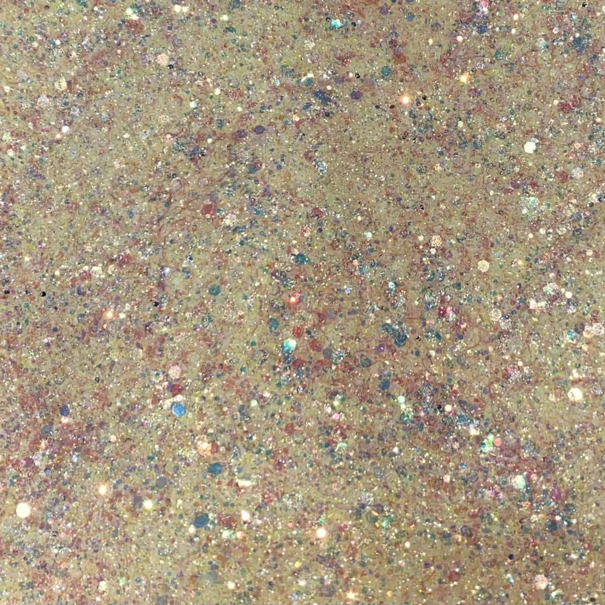 Close-up of iridescent yellow and pink glitter eyeshadow with sparkling flecks in canary shade