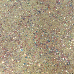 Close-up of iridescent yellow and pink glitter eyeshadow with sparkling flecks in canary shade