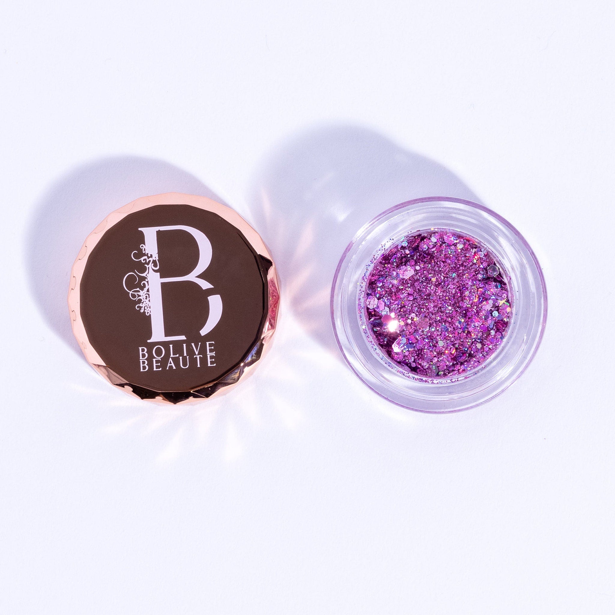 Pink and purple glitter eyeshadow palette with shimmering metallic finish in compact case