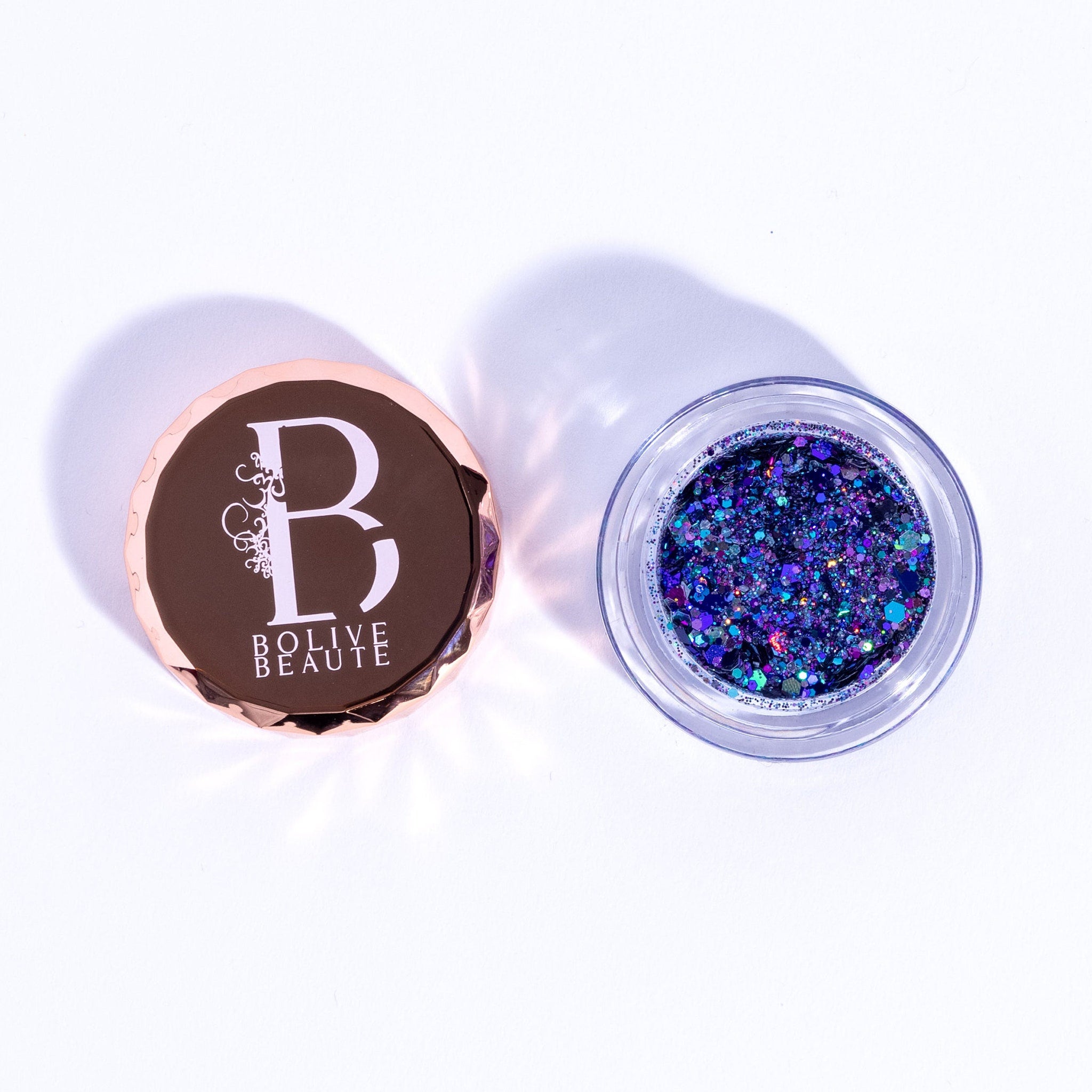 Dual-tone indigo and deep purple glitter eyeshadow palette with shimmer finish in compact case