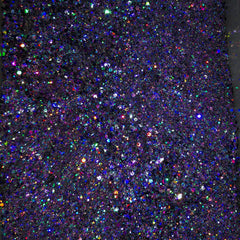 Close-up of indigo and deep purple glitter eyeshadow palette with shimmering metallic finish