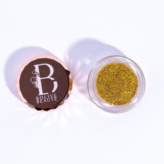 Close-up of Holographic Gold Glitter Eyeshadow in round pan with reflective rainbow shimmer particles
