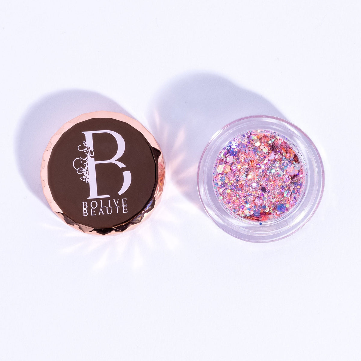 Close-up of Pink Glitter Eyeshadow in round compact with shimmering rose gold particles and satin finish