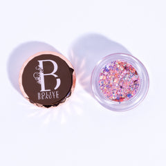 Pink glitter eyeshadow with rose gold lid, clear container, and "BOLIVE BEAUTE" text
