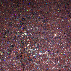 Close-up of vibrant pink glitter eyeshadow with shimmer particles in compact case