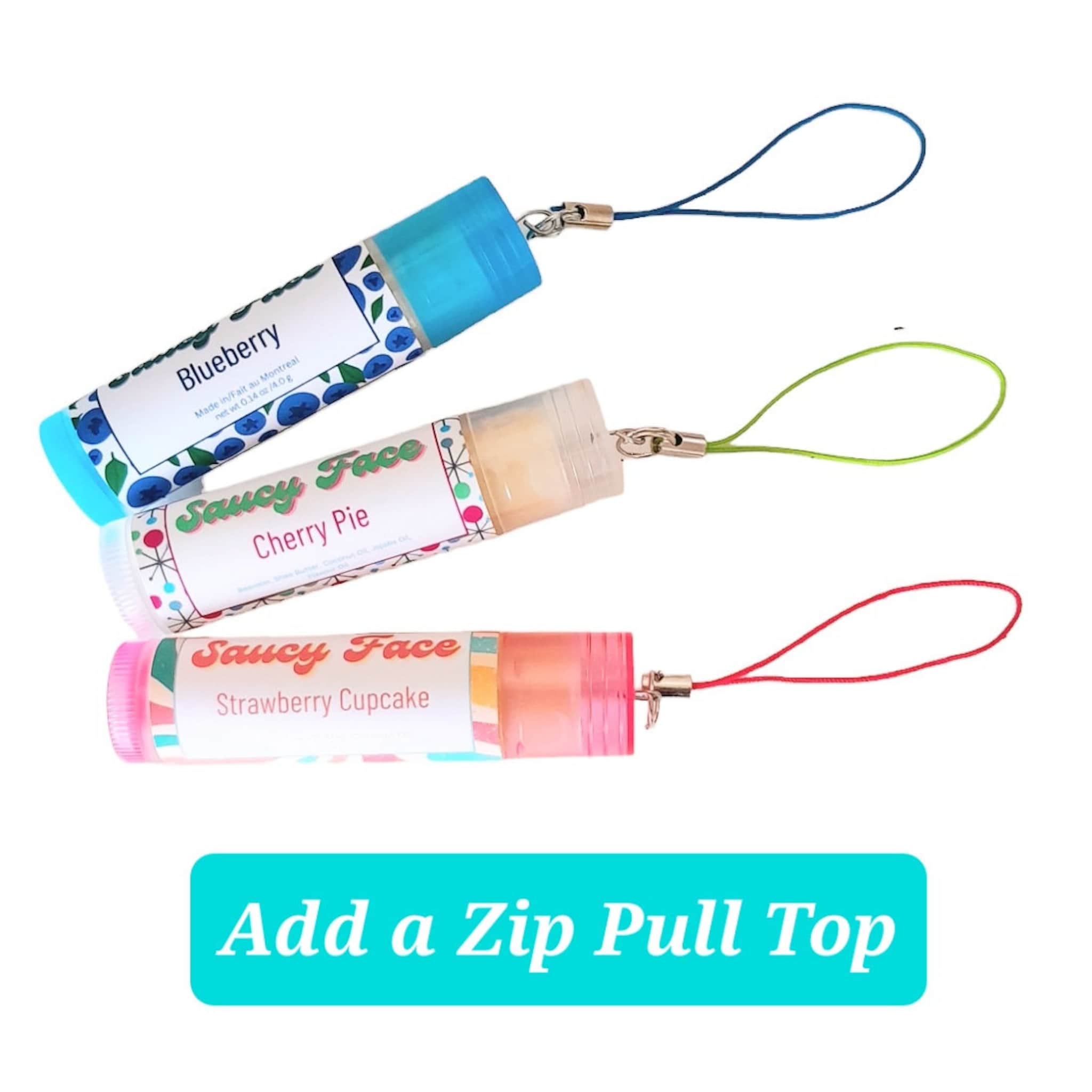 Lip balm tubes with blue, clear, and pink caps, attached lanyards, and brand text visible