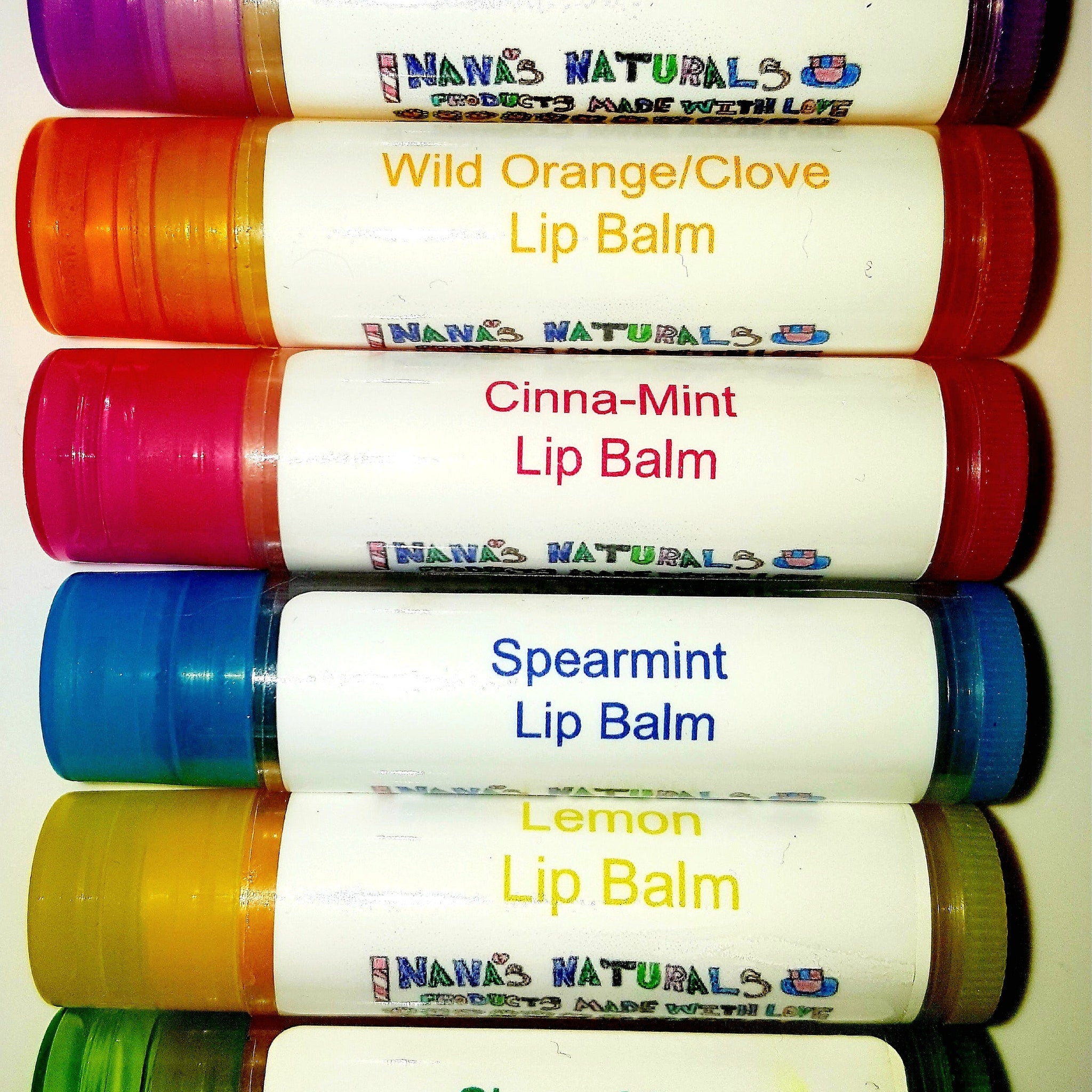 Lip balm tubes with various colored caps, white labels, and "NANA'S NATURALS" text visible