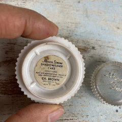 Side view of Vintage Monica Simone eyeshadow compact showing retro floral pattern and gold-trimmed edges