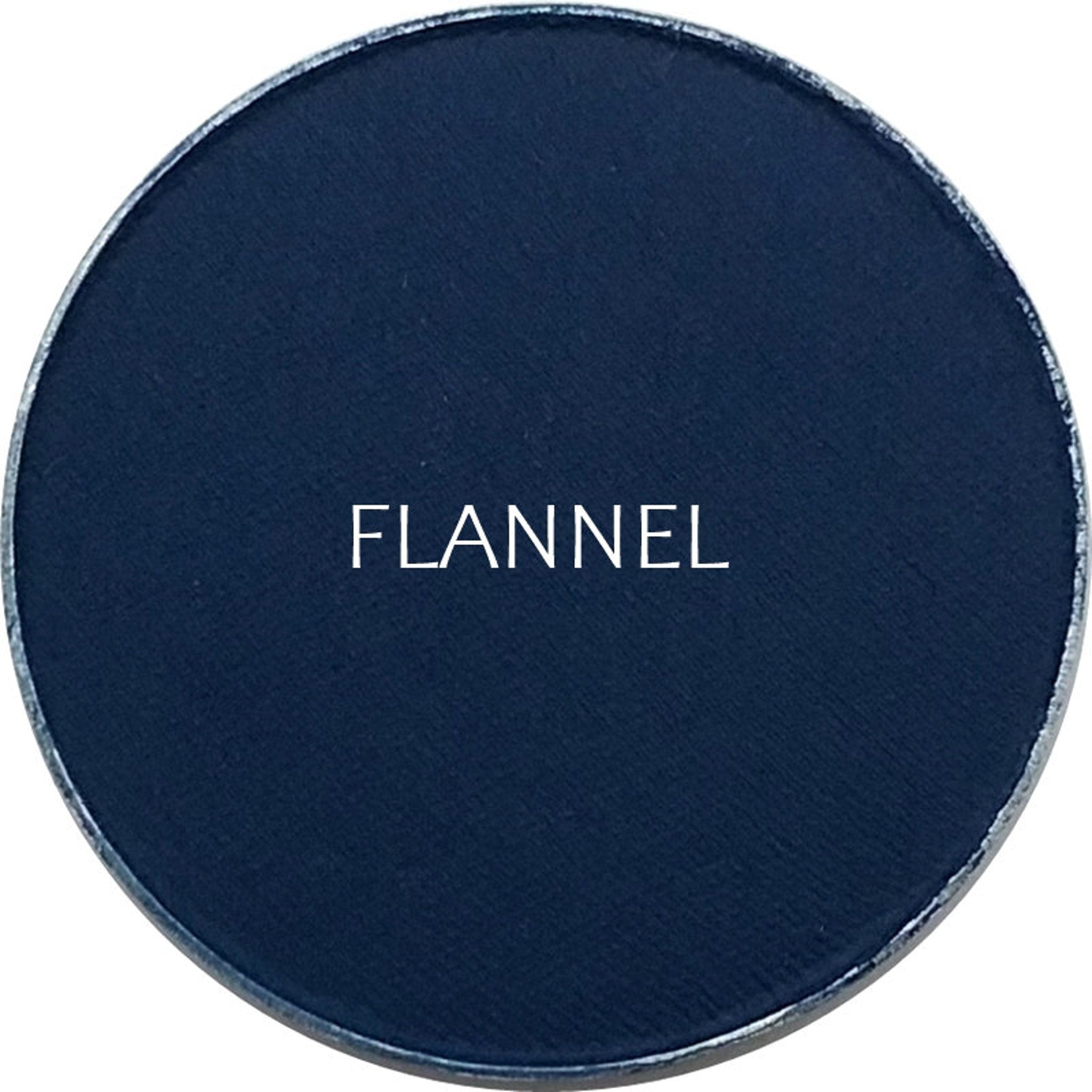 Side view of matte flannel eyeshadow pan showing soft powder texture and neutral taupe color