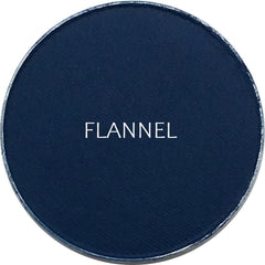 Side view of matte flannel eyeshadow pan showing soft powder texture and neutral taupe color