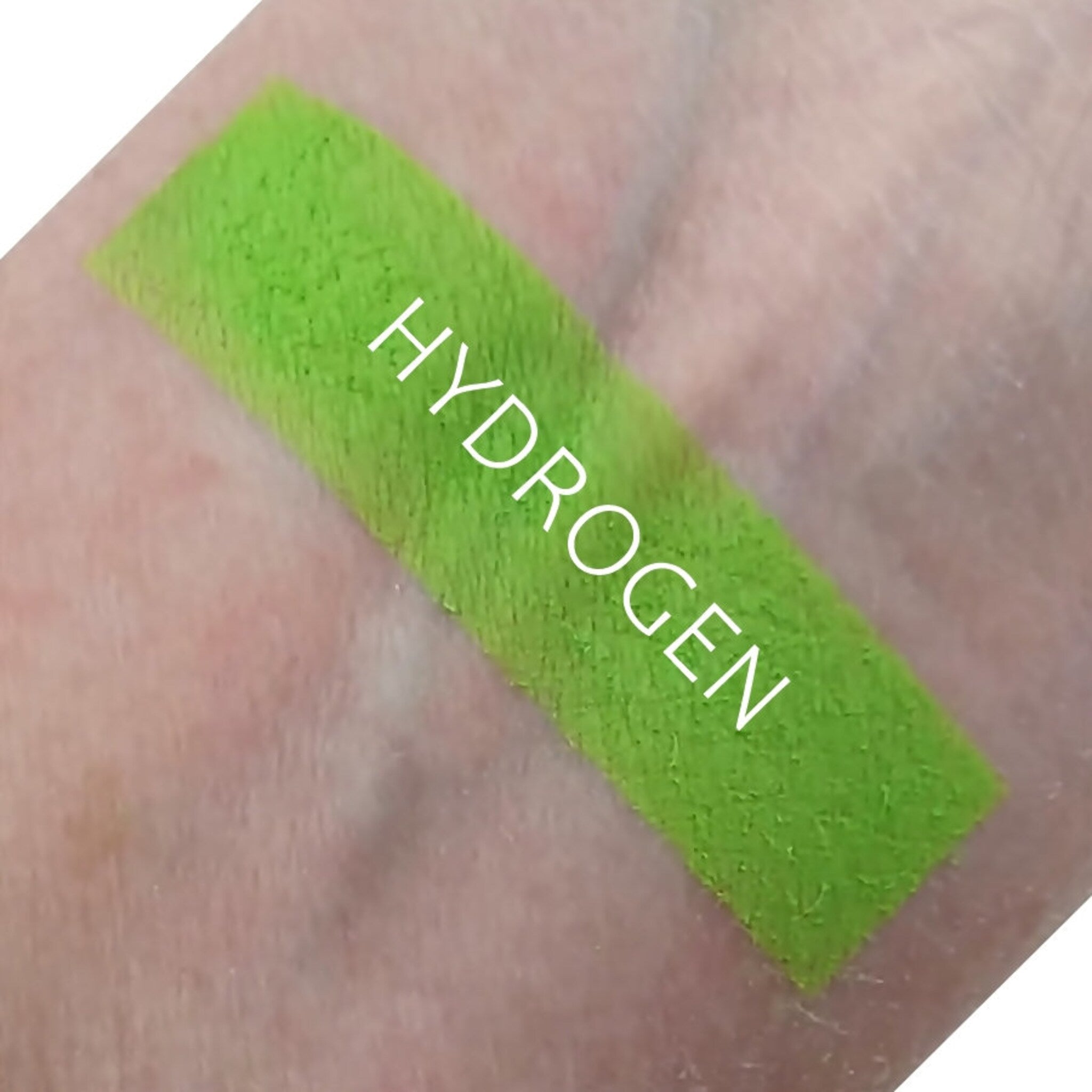Single matte hydrogen eyeshadow pan in a sleek black compact with visible powder texture