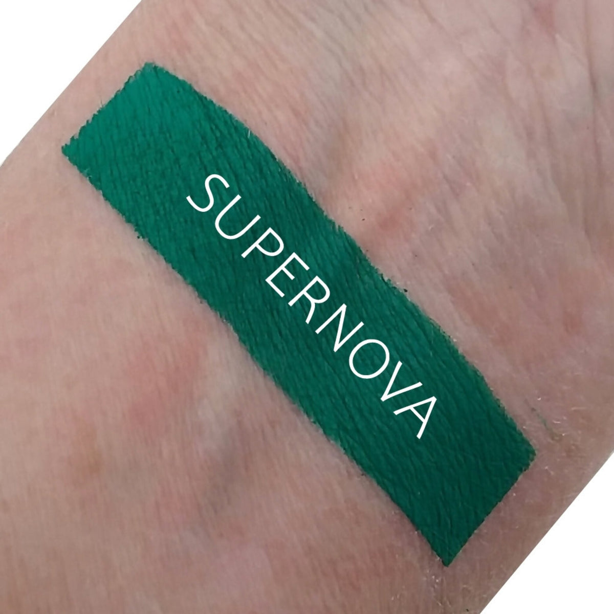 Front view of Matte Supernova Eyeshadow in a sleek black compact with color swatch showing rich pigment texture