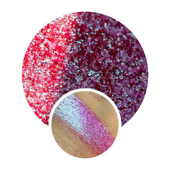 Close-up of shimmery multichrome eyeshadow shifting between iridescent hues in a compact pan.
