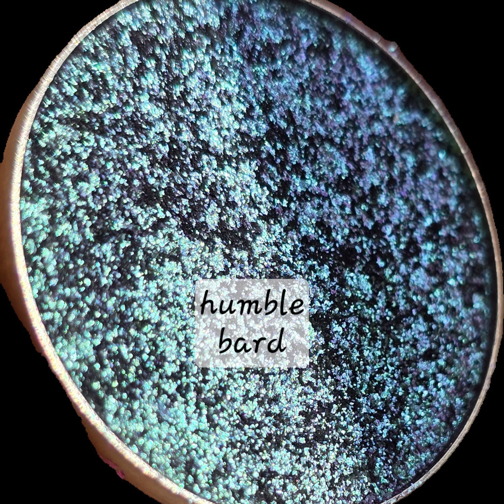 Extreme close-up of shimmery multichrome eye shadow shifting between vibrant hues with sparkling flecks