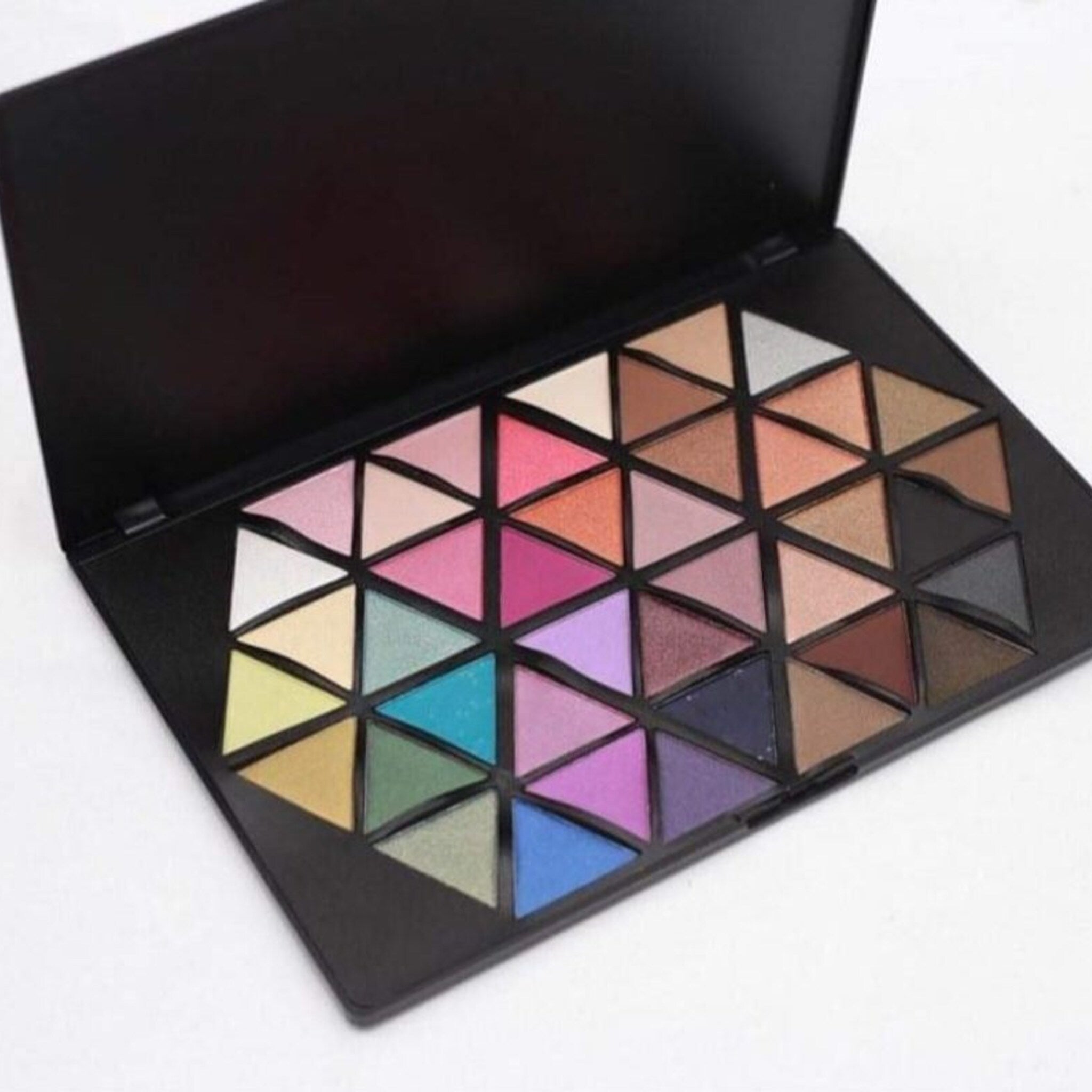 Vivid Cosmetics eyeshadow palette open with 12 vibrant matte and shimmer shades in a sleek black compact