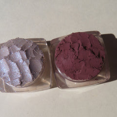 Side view of three purple shimmer loose mineral eyeshadows in matte dark mauve with vegan labeling