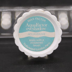Eyeshadow compact with white scalloped edge, teal and white label, Max Factor brand name visible