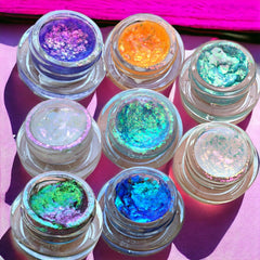 Close-up of creamy chrome eyeshadow pot showing metallic sheen and smooth texture in a rich bronze shade