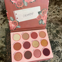 Side view of Colourpop Whatever Palette showing 12 pressed powder shadows in matte and shimmer finishes with mirror
